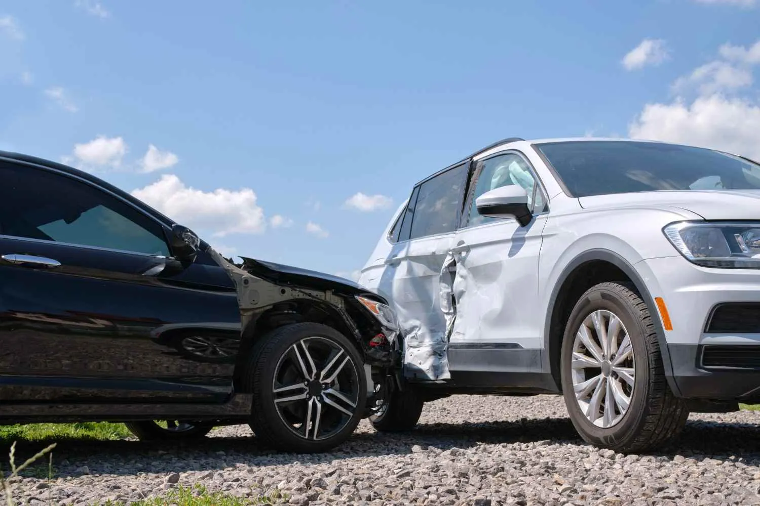 Two cars after a side collision on a gravel road